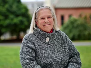 A woman wearing a cozy sweater, radiating warmth and contentment